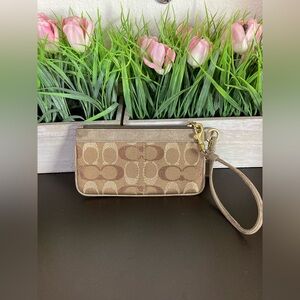 Coach excellent used condition brown and gold wristlet